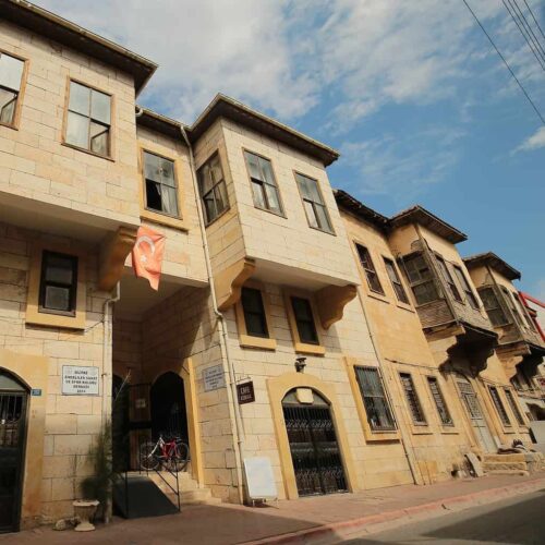 flag hanging on traditional stone house on street