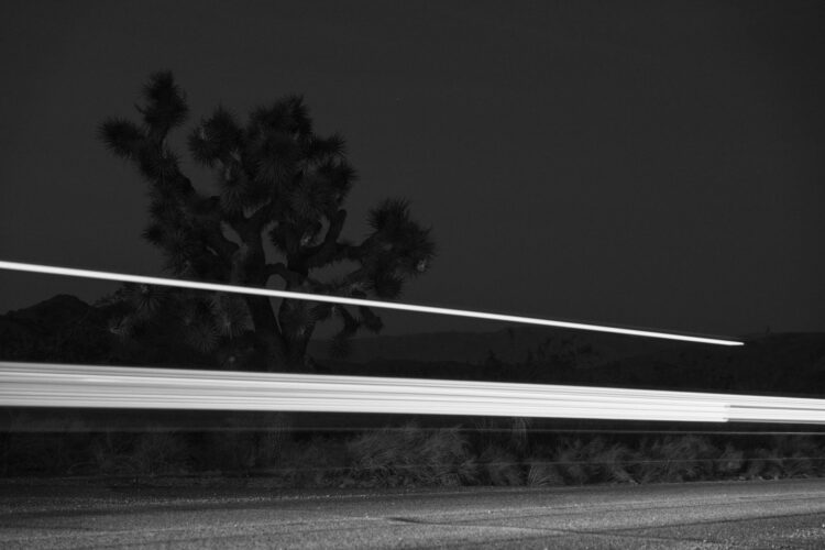 flashlights glow over dirt road in desert outskirts